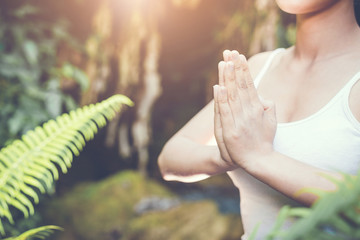 Woman Yoga - relax in waterfall nature.
