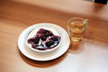 Blueberry cheese cake with chinese green tea on the wooden table