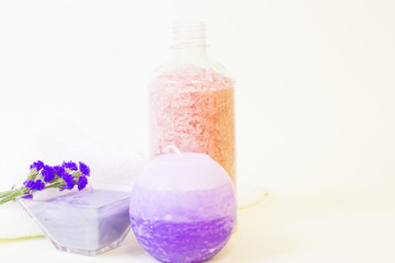 Obraz na płótnie Canvas Aromatherapy spa concept. Pink and blue sea salt, blue candle, closeup