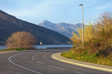 Sharp turn of road. View of Adriatic Highway (Jadranska magistrala) running along the coast of Bay of Kotor . Montenegro, winter