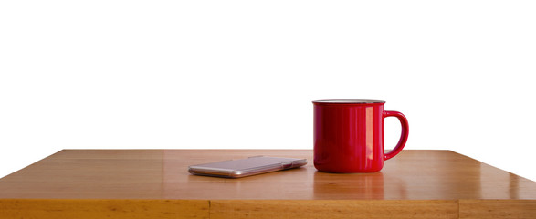 A red cup on wooden table isolated on white background.