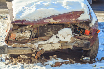 old broken car after an accident in the snow