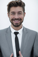 handsome young man in suit on grey background