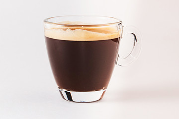 Coffee americano in a transparent cup and saucer on a white background