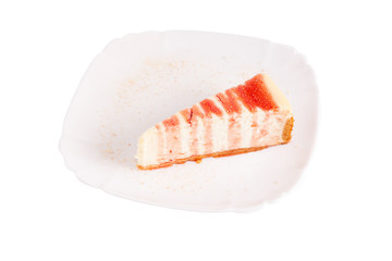 classic cheesecake watered with berry sauce on a white plate isolated on white