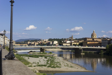 Fototapeta na wymiar Florence cityscape at day time in summer season, with Amerigo Vespucci bridge in the foreground