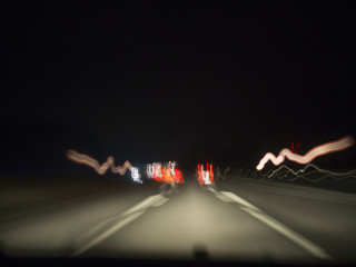 Lights of cars at night while driving on a highway