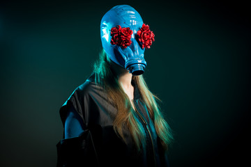 Long haired girl in a blue gas mask