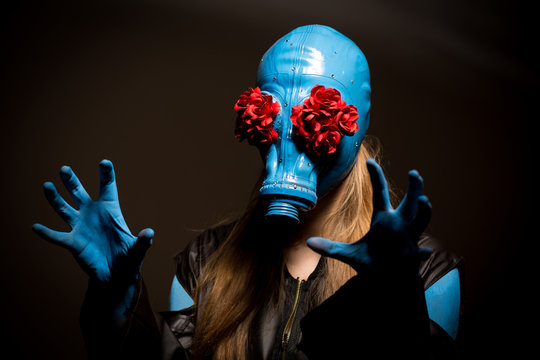 Creepy girl with blue skin and in a gas mask