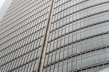 Glass surface of skyscrapers view in district of business centers with reflection on it, black and white