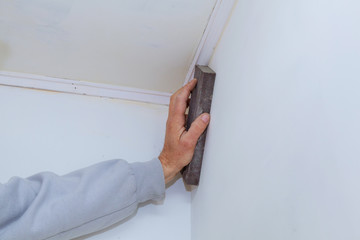 Gypsum panel in the form of on the wall. Master plasterer smooths the seams with plaster between...
