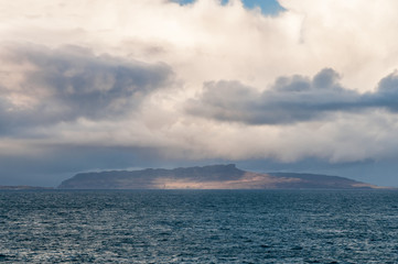 Eigg / The sunlit Isle of Eigg, one of the Small Isles, taken from Ardnamurchan, Lochaber,Scotland. 01 January 2018
