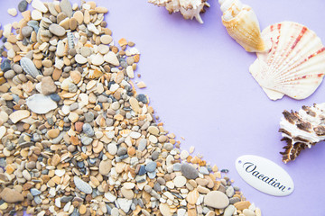 Vacation concept. White sand, small stones and seashells, top view, flat lay