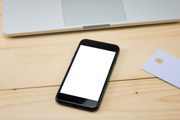 Office desk table with blank screen smart phone