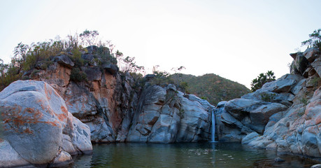 Fototapeta na wymiar Waterfall and natural swimming pool at Cascada Sol Del Mayo on the Baja California peninsula in Mexico BCS