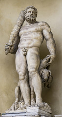 Fototapeta na wymiar Statue of Hercules with a three headed dog at entrance of the Ducal Palace in Modena, Italy