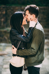 Spring photo session of a beautiful young couple in the old courtyards of the city.