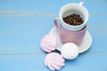 Coffee with sweets on a blue wooden background