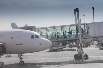Fototapeta premium Passenger wide-body plane go through the bridge to the airport