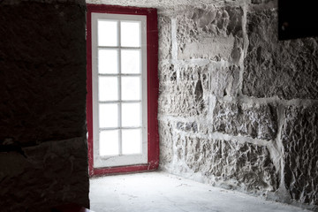 red window frame, old brick walls
