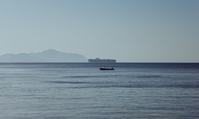 Egypt panoramic view os Red sea and Tiran island taken from Sharks Bay in Sharm el Sheikh with blue sky and water at summer evening