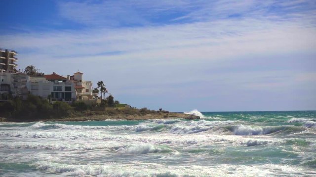 Slow motion 120fps shoot of sea waves breaking on a the coast. Mediterranena sea waves in Altafulla, Spain.