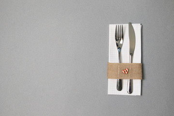 white napkin, knife and fork, place for dinner served in rustic style
