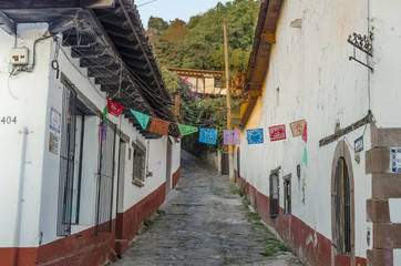 View of a typical street decorated with colorful cut paper in Valle de Bravo, magical town near to Mexico City