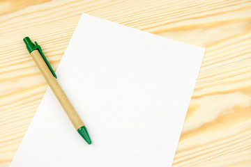 Sheet of white paper mockup on wooden background