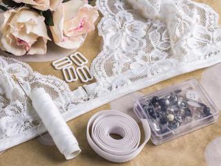 Tools and materials for sewing lace lingerie. Desk tailor master. Creative process moments. Bralette handmade.