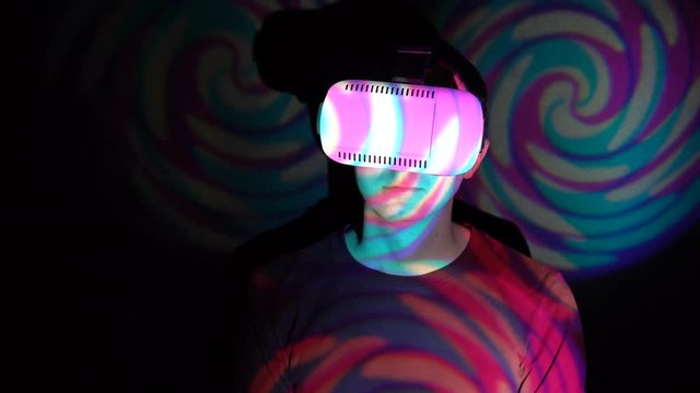Portrait of man using VR-helmet in the spotlight