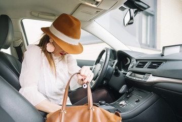 Naklejka premium Beautiful young woman look for the smartphone in the bag