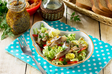 Easter recipe, festive snack. Salad with Pekinese cabbage, herring, sweet pepper and onions - on the festive table.