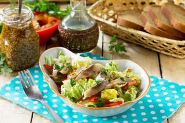 Easter recipe, festive snack. Salad with Pekinese cabbage, herring, sweet pepper and onions - on the festive table.