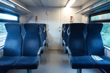 Obraz premium Salon of a modern train without people. On the armchair lies the news paper