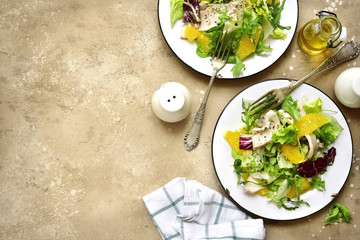 Detox salad from mix of salad leaves, chicken fillet and oranges.Top view with copy space.