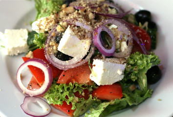 greek salad of fresh vegetables on a plate close up