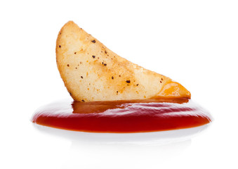 Cooked spicy potato wedges snack with ketchup