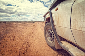 South Australia – Outback desert with 4WD on track under cloudy sky - vintage