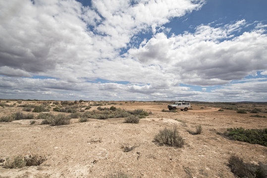 South Australia – Outback desert with 4WD track under cloudy sky as panorama - vintage