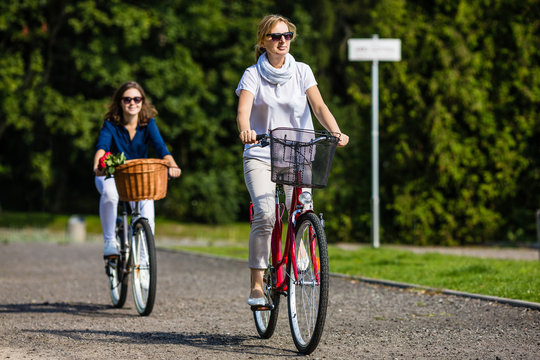 Women biking in city park