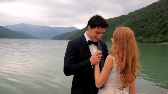 Loving couple on the background of the river and mountains. Georgia