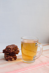 Small pieces of chocolate cake Brownie lie on a napkin and cup o