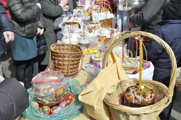Baskets containing a sampling of Easter foods on the table, at the yard of Eastern Orthodox temple, to be blessed on Holy Saturday.