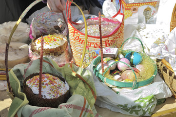 Baskets containing a sampling of Easter foods on the table, at the yard of Eastern Orthodox temple, to be blessed on Holy Saturday.