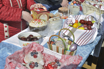 Fototapeta premium Baskets containing a sampling of Easter foods on the table, at the yard of Eastern Orthodox temple, to be blessed on Holy Saturday.
