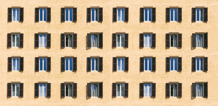 Wooden windows with shutters on a residential building facade, banner