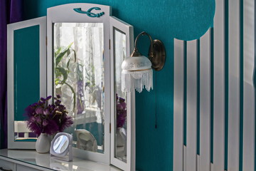 Interior 2. Dressing table, vase, mirror, sconce. Bedroom in turquoise tones.