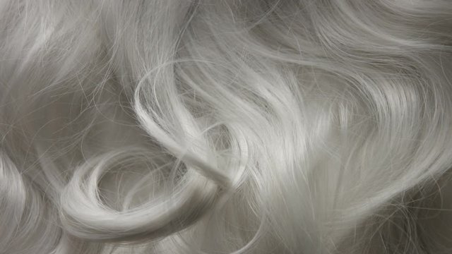 Curly large white grey eldery hair.Slowmotion how falling a curl to hair texture