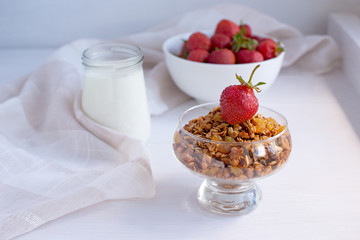 Homemade granola in jar on rustic kitchen table, healthy breakfa